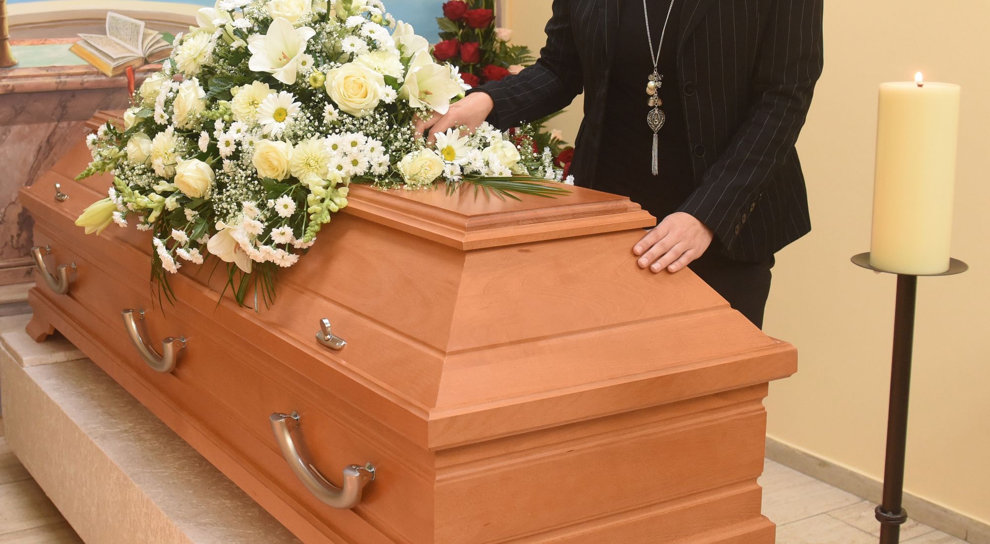 Ein Trauernder nimmt Abschied am Sarg